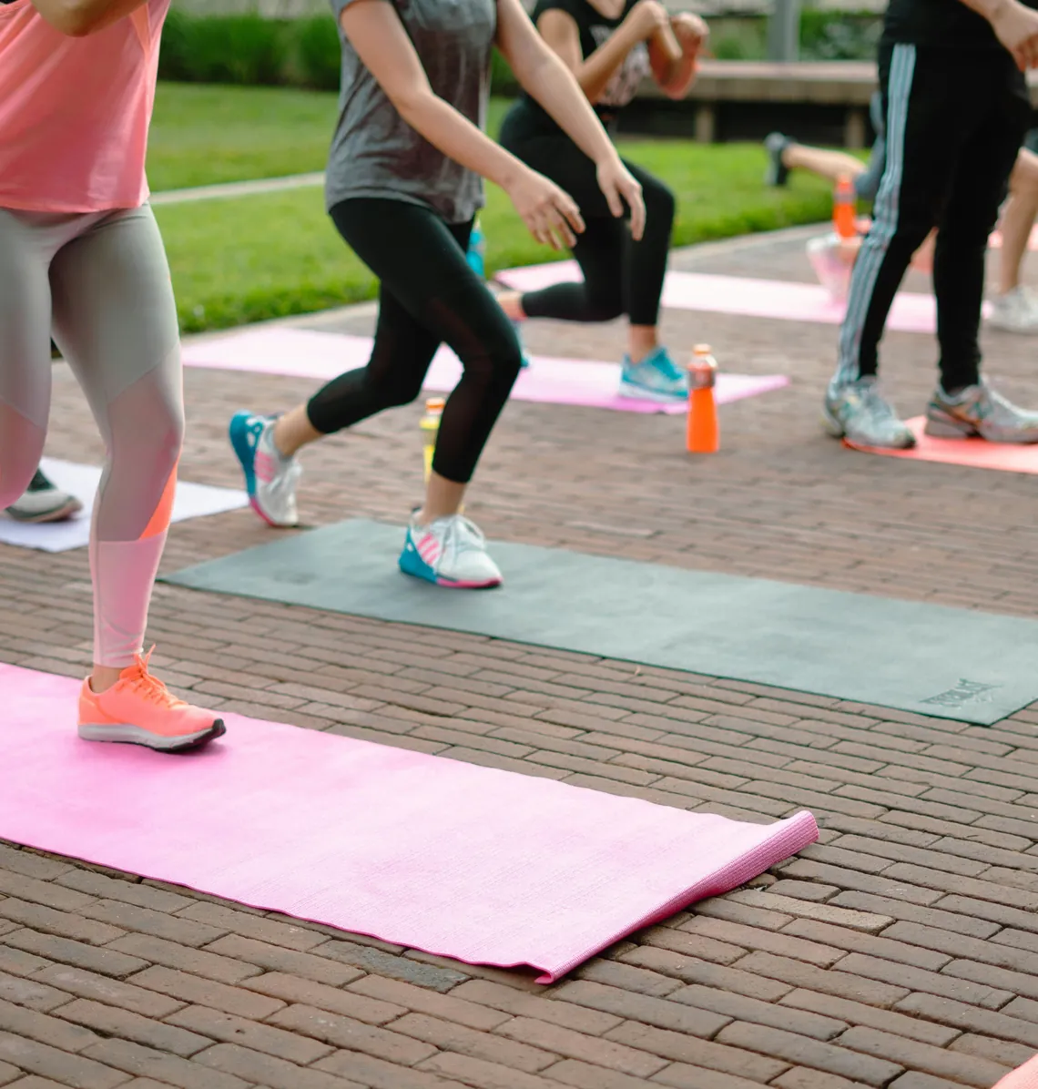 Yoga mats on a brick floor during an outdoor class