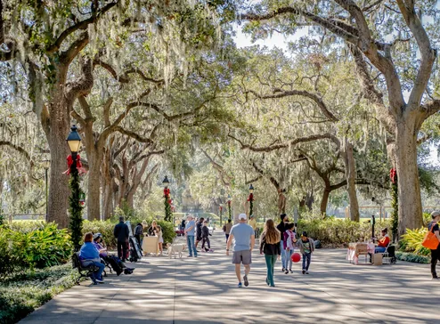 Walkers under the live oaks of Forsyth Park
