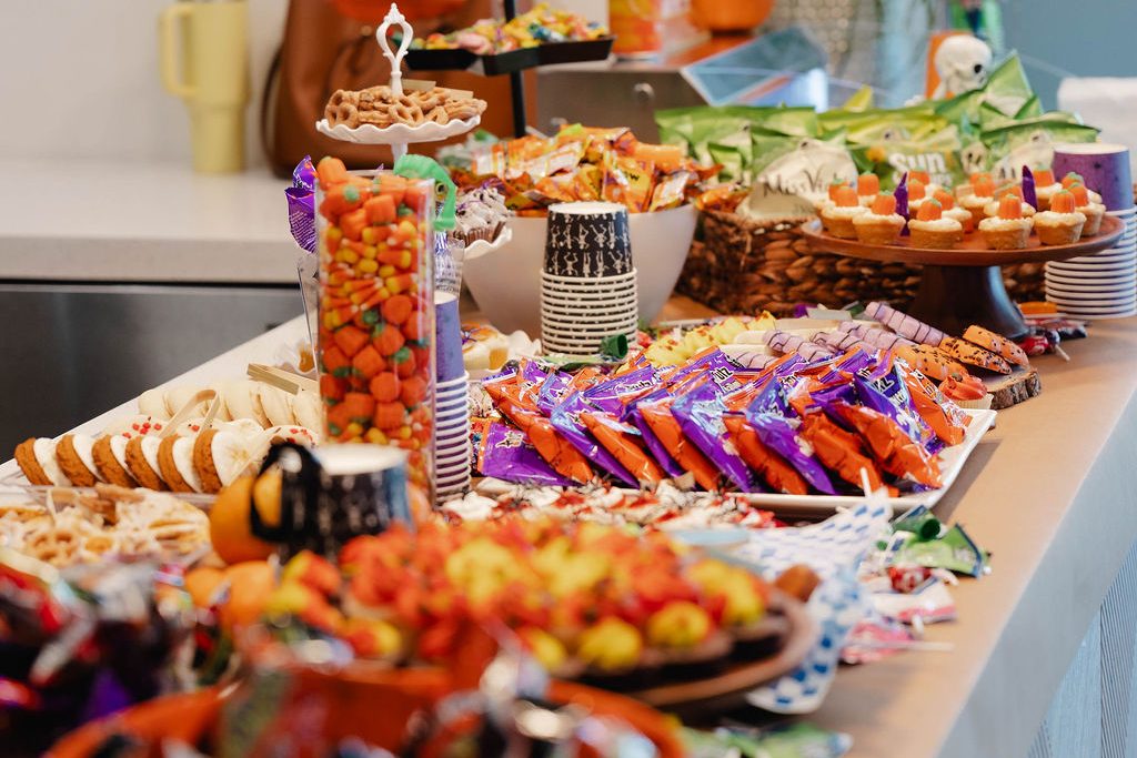 Fall Festival treat table filled with Halloween candy, cupcakes and snacks Fall Festival treat table filled with Halloween candy, cupcakes and snacks