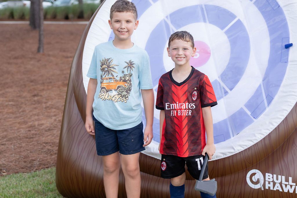 Two boys in front of the giant inflatable dartboard Two boys in front of the giant inflatable dartboard