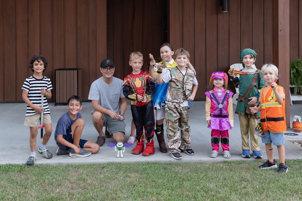 Group of kids in Halloween costumes lined up on the porch Group of kids in Halloween costumes lined up on the porch