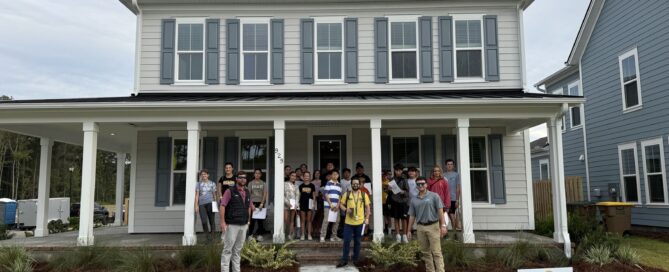 Seventh-grade STEM students and PulteGroup team members in front of a Pulte home at Heartwood